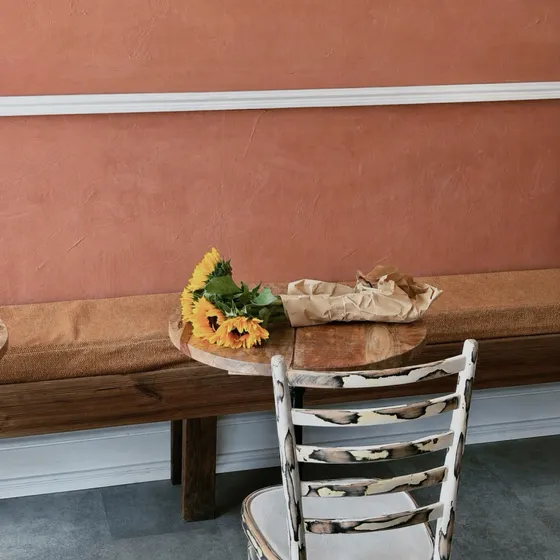Sunflowers resting on a wooden bench