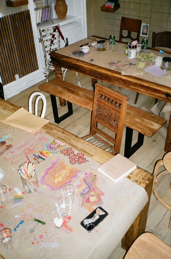 A table covered in paints and works in progress